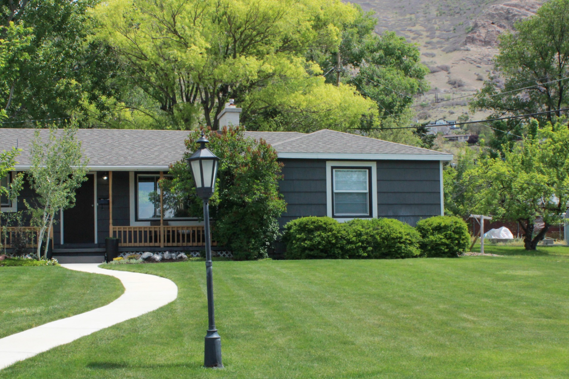 Cottage home with manicured striped lawn at the foothills