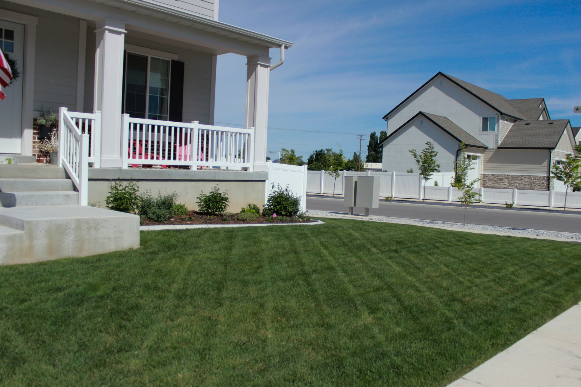 Front yard with crisp mow stripes on deep green grass